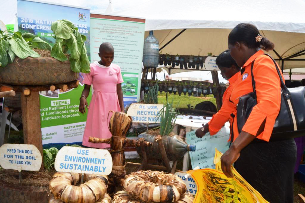 1. Pupils under Masaka junior land case their products with their teachers at ULN stall in Lukaya town council during the agricultural exhibition.